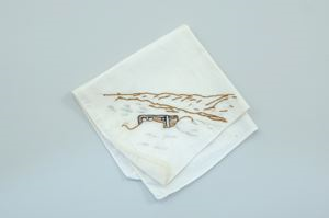 Image: Sledge with brown mountainous landscape, one of a set of 4 embroidered napkins with scenes of Inuit ice life